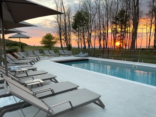 a row of lounge chairs next to a swimming pool at CLIFF Trzęsacz - sea view apartments in Trzęsacz