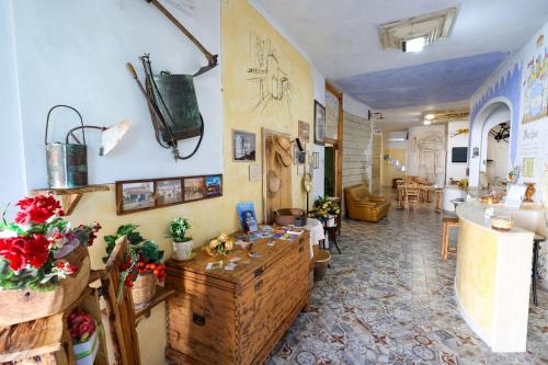 a living room with a counter and a living room with a room at Antico Borgo Marchese in Morciano di Leuca