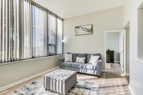 a living room with a couch and a large window at Columbia Vacation Rental - Walk to UofSC Campus! in Columbia