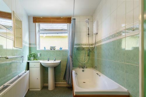 a bathroom with a sink and a bath tub and a sink at 1 White Street New Quay in New Quay