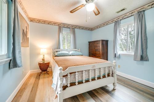 a bedroom with a white bed in a room with windows at Wilmington Getaway Near Carolina Beach Boardwalk! in Wilmington