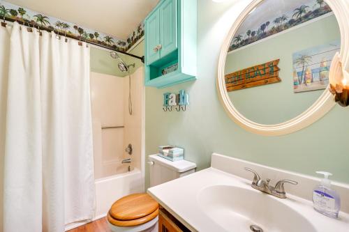 a bathroom with a sink and a toilet and a mirror at Wilmington Getaway Near Carolina Beach Boardwalk! in Wilmington