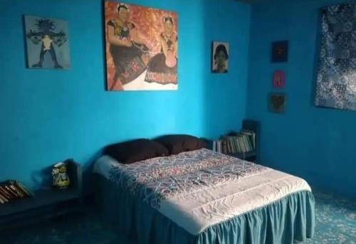 a blue bedroom with a bed in a blue wall at POSADA HORTENCIA in Aguascalientes