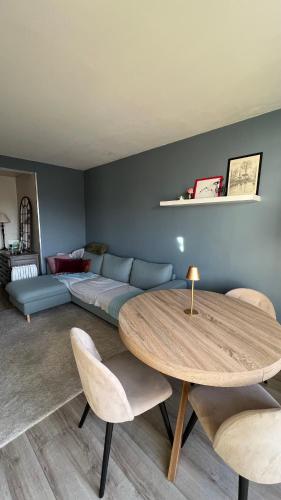 un salon avec une table et un canapé dans l'établissement L'Hay-les-Roses proche RER Paris, à LʼHay-les-Roses