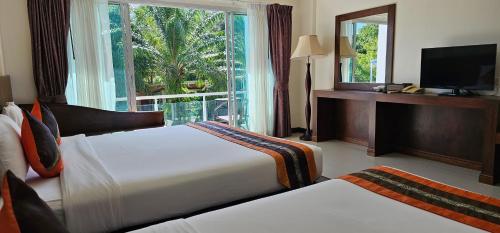 a hotel room with two beds and a window at The Pano Hotel And Residence in Ban Khlong Haeng