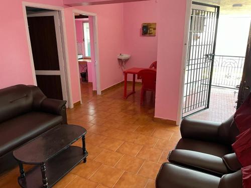 a living room with a couch and a table at Valley Villa 2BHK in Kodaikānāl
