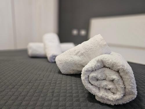 two rolled up towels sitting on a table at New Bazar-Central Apartment 1 with balcony in Tirana