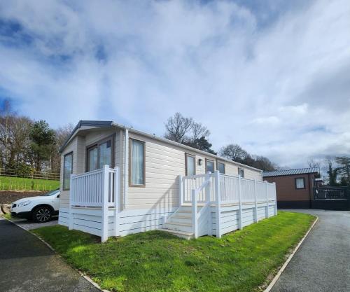 a tiny house parked in a parking lot at Serene Stay: Beautiful 2Bed Lodge in Kelsall in Kelsall