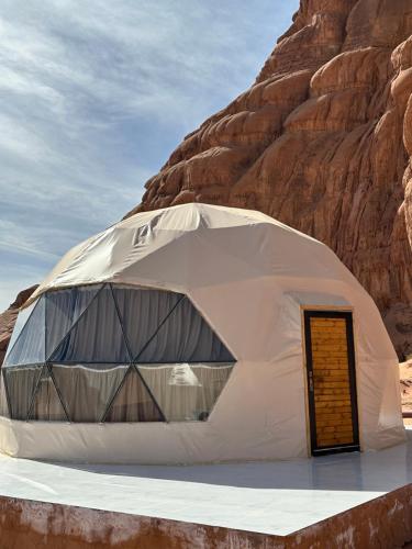 a dome tent in the middle of a desert at Wadi Rum Grand in Wadi Rum