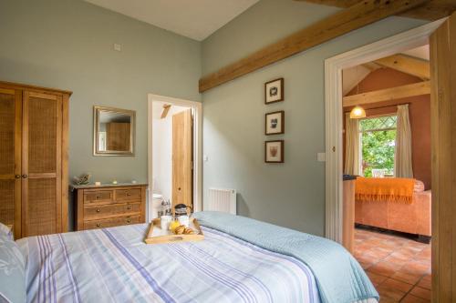 a bedroom with a bed with a tray on it at Thyme Lodge Drefach Felindre in Felindre