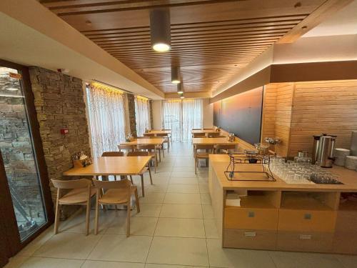 a restaurant with tables and chairs in a room at Hotel Jirinka in Dolní Morava