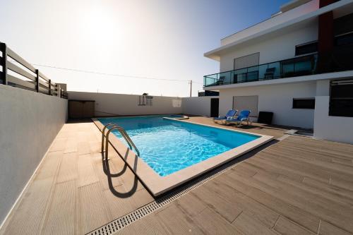 a swimming pool on the roof of a building at Luxury Apartments Baleal in Baleal