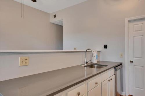 a kitchen with a sink and a counter top at Breathtaking Unit in Shaw - 4 Queen beds 1E in Tower Grove