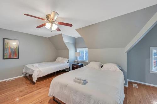 a bedroom with two beds and a ceiling fan at Entire Building in Shaw Community in Tower Grove