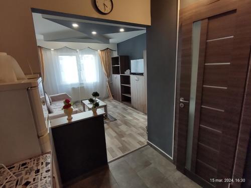 a room with a kitchen with a door and a counter at Casa lui Andrei in Braşov