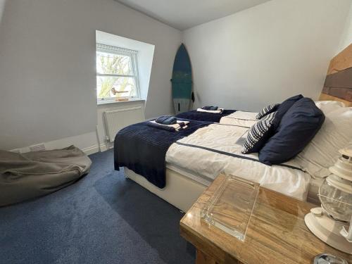 a bedroom with a bed with a dog laying on it at The Beach House Holiday Apartments in Eastbourne