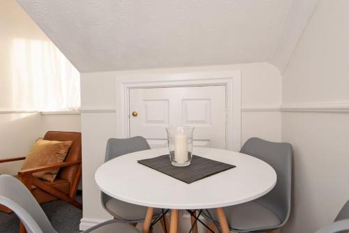 a white dining room table with a candle on it at Central Washington Apartment in Washington