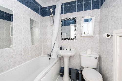 a bathroom with a sink and a toilet and a bath tub at Central Washington Apartment in Washington