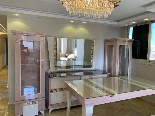 a room with a dresser and a chandelier at شقة جديدة بالكامل in Port Said