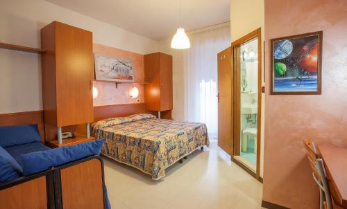 a bedroom with a bed and a couch in it at HOTEL AZZURRA in Senigallia
