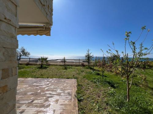 a view of the ocean from a house at MUMBAS APARTMENT DHERMI in Gjilek
