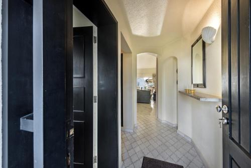 a hallway with a black door and a tile floor at Mng Elliott42 in Vale do Lobo