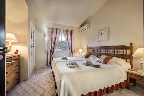 a bedroom with a large bed with towels on it at Mng Elliott42 in Vale do Lobo