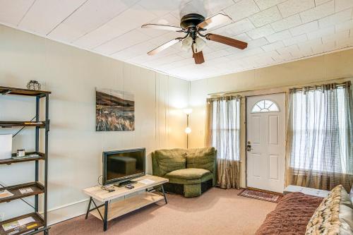 a living room with a ceiling fan and a tv at Matewan Vacation Rental Near Devil Anse Trail! 