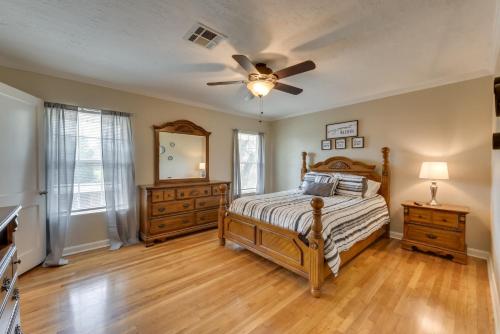 a bedroom with a bed and a ceiling fan at Cozy Lake Charles Apartment 2 Mi to Downtown in Lake Charles
