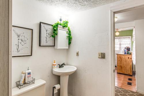 a bathroom with a sink and a mirror at Matewan Vacation Rental Near Devil Anse Trail! 