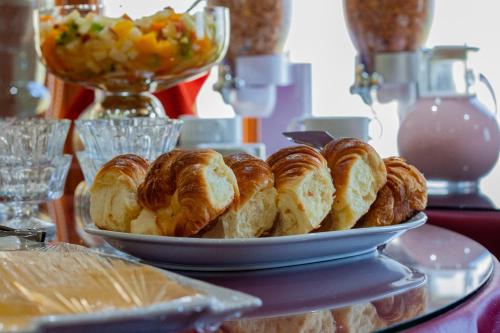 a plate of croissants and other pastries on a table at Hotel Villa Brescia in Ushuaia