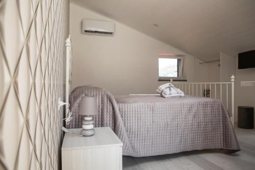a bedroom with a bed and a table with a lamp at Dreams in Gragnano