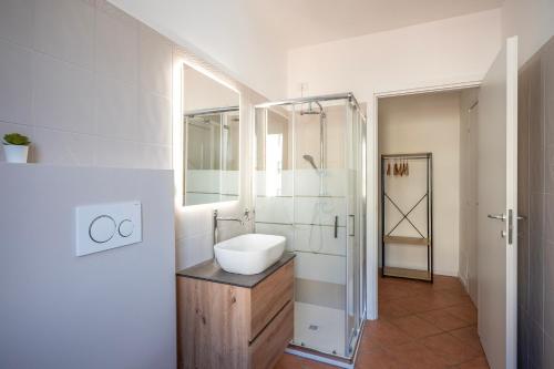 a white bathroom with a sink and a shower at Bologna41 in Parma