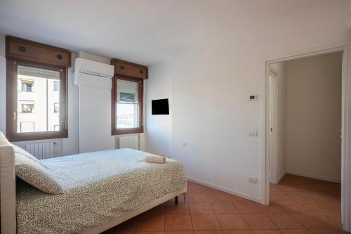 a bedroom with a bed and a window and a mirror at Bologna41 in Parma