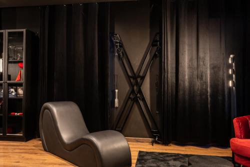 a black chair in a room with a microphone at BlackRoom Suite de Luxe 50 Nuances de grey in Le Havre