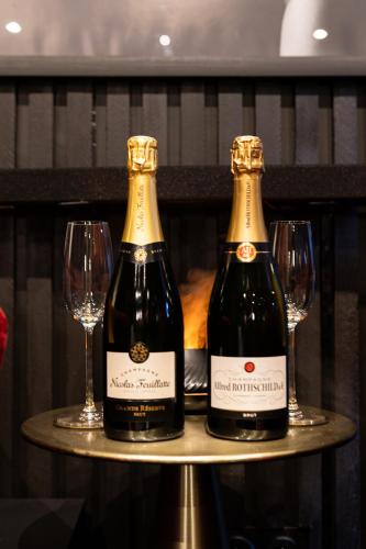 - deux bouteilles de vin assises sur une table avec des verres dans l'établissement BlackRoom Suite de Luxe 50 Nuances de grey, au Havre