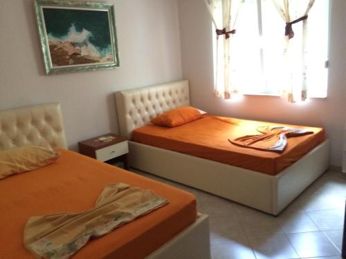 a bedroom with two beds and a window at Apartment Eurocoli Rezidence in Golem
