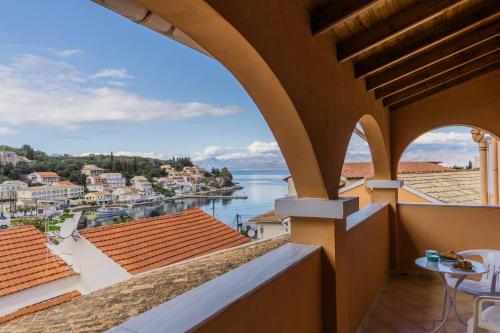 a balcony with a view of the water at Porto Kassiopi Apartments in Kassiopi