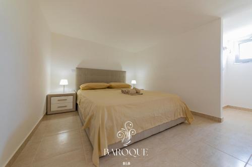 a bedroom with a bed and a table with a lamp at Baroque B&B in Lecce