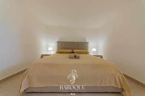 a bedroom with a bed with a be hospice sign on it at Baroque B&B in Lecce