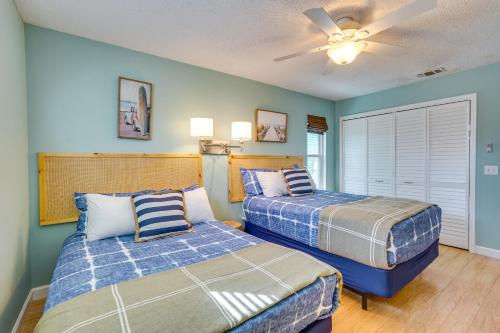 a bedroom with two beds and a ceiling fan at Panama City Beach Home Steps to the Ocean! in Panama City Beach