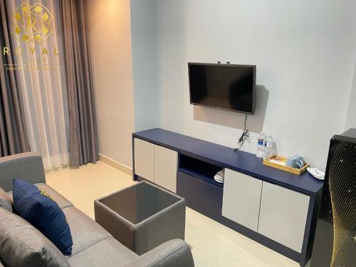 a living room with a couch and a flat screen tv at Apartment Pollux Habibie 2BR 11th Floor By Royal Suites in Batam Center