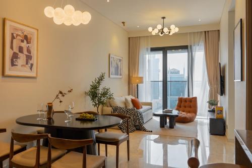 a living room with a table and a couch at The MARQ Elite Apartel District 1 HCMC by SSens in Ho Chi Minh City