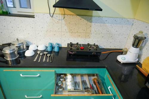 a kitchen with a counter with a sink in it at Classe Moyenne -2BHK, Near US Embassy, Gachibowli in Hyderabad