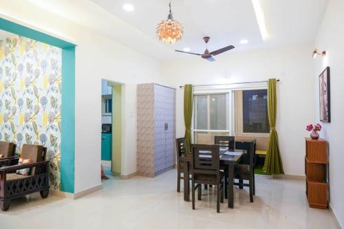 a dining room with a table and chairs at Classe Moyenne -2BHK, Near US Embassy, Gachibowli in Hyderabad