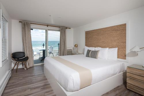 a bedroom with a bed and a view of the ocean at Stones Throw in York Beach