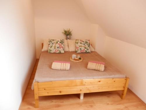 a bedroom with a wooden bed in a attic at Apartment Peter in Donovaly