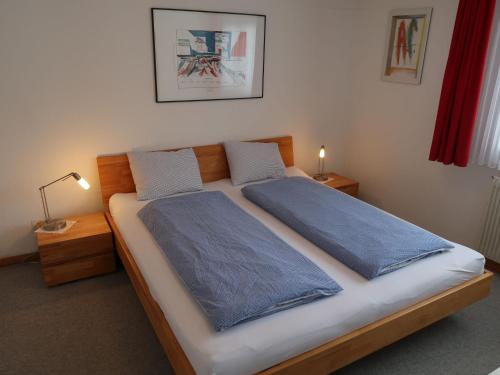 a bedroom with a bed with two pillows on it at Holiday Home Peisel by Interhome in Disentis