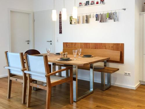 a dining room with a wooden table and chairs at Holiday Home Sophia by Interhome in Dittishausen