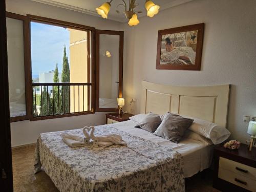 a bedroom with a bed with a towel on it at Holiday Home Balcon de Finestrat by Interhome in Finestrat